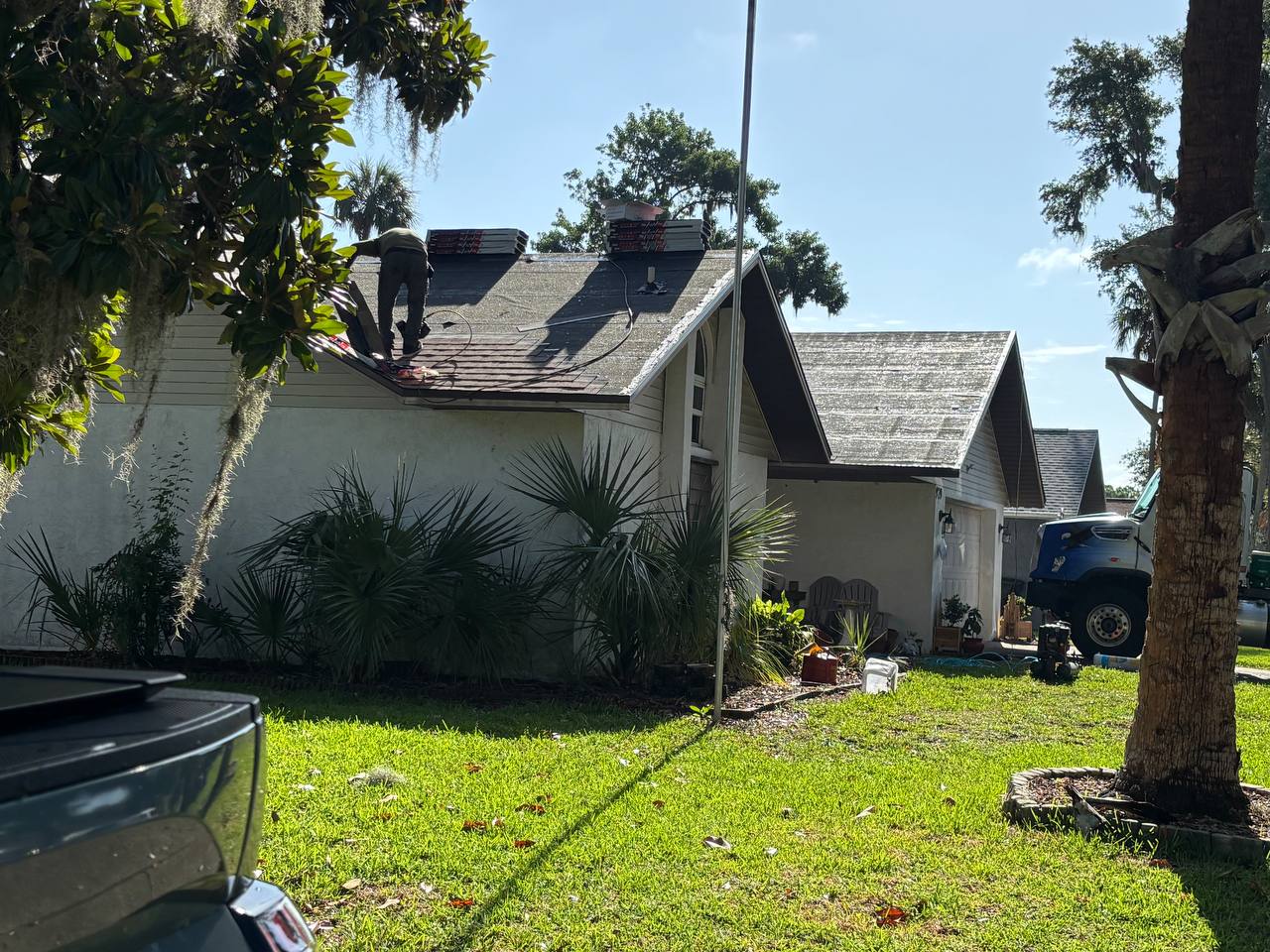 Affordable Roofing crew installing shingles on residential home in Volusia County Florida