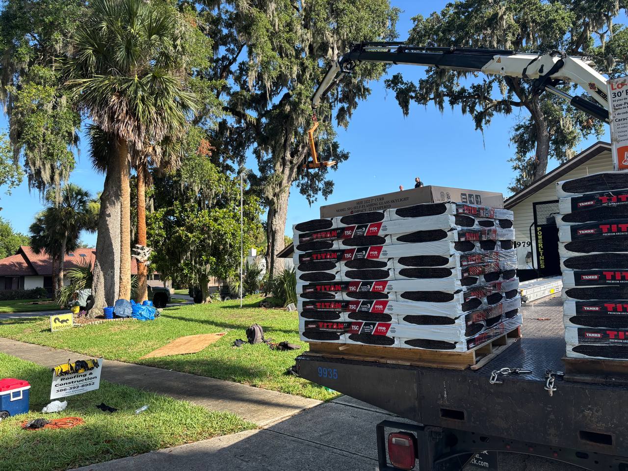 Tamko Titan XT shingles delivery at active roofing job site in Port Orange FL — Affordable Roofing and Construction